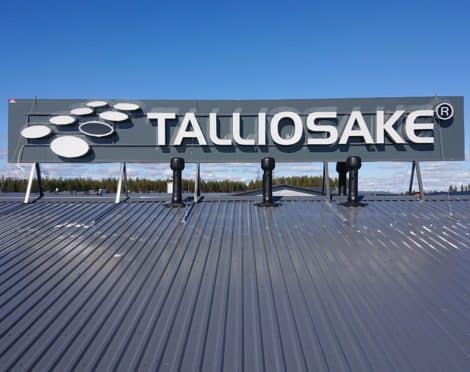 Irtokirjain valomainos katolla, taustalevyllä